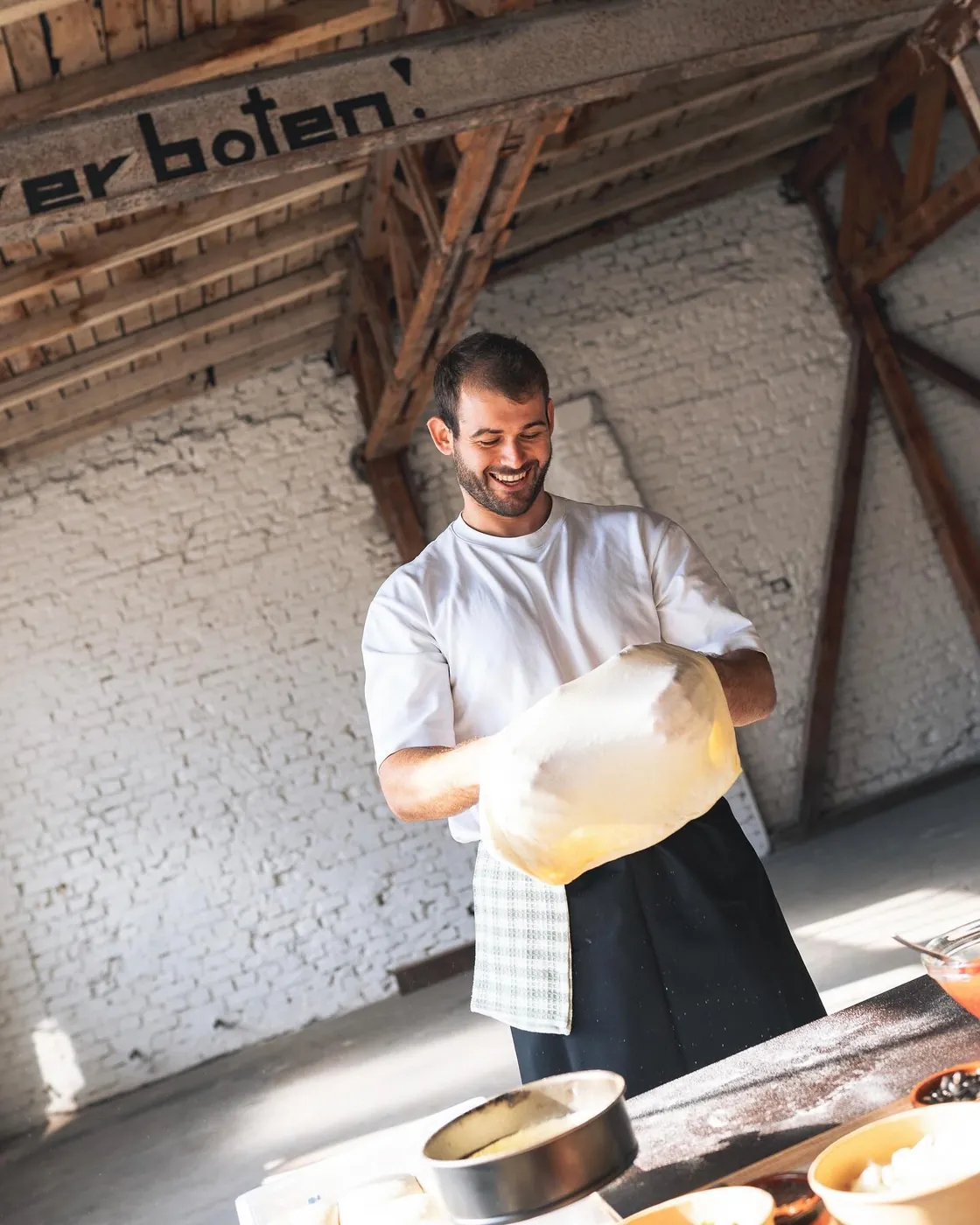 Hands stretching pizza dough
