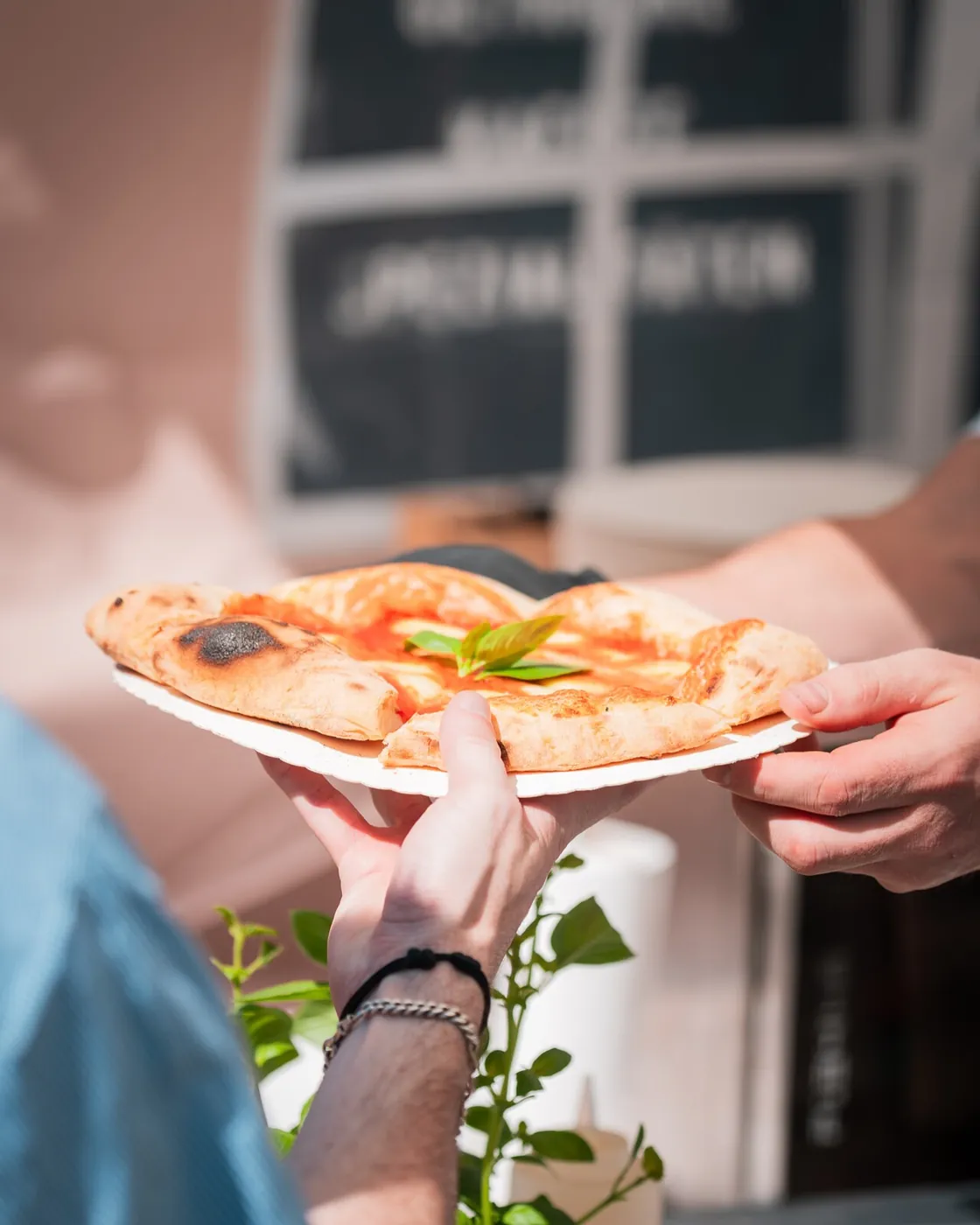 A slice of pizza handed over the counter